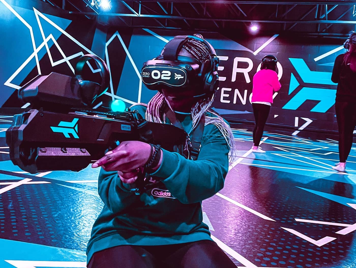 Fille jouant à un jeu de réalité virtuelle dans l'arène de Zero Latency Montréal